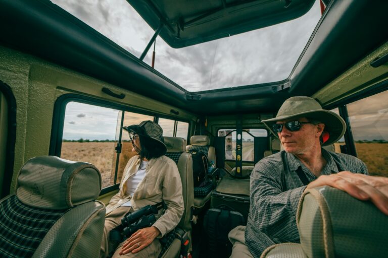 Couple on a game drive in an open vehicle