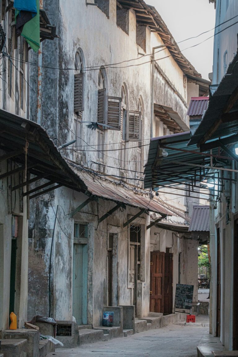 Narrow Stone Town alley with a clock